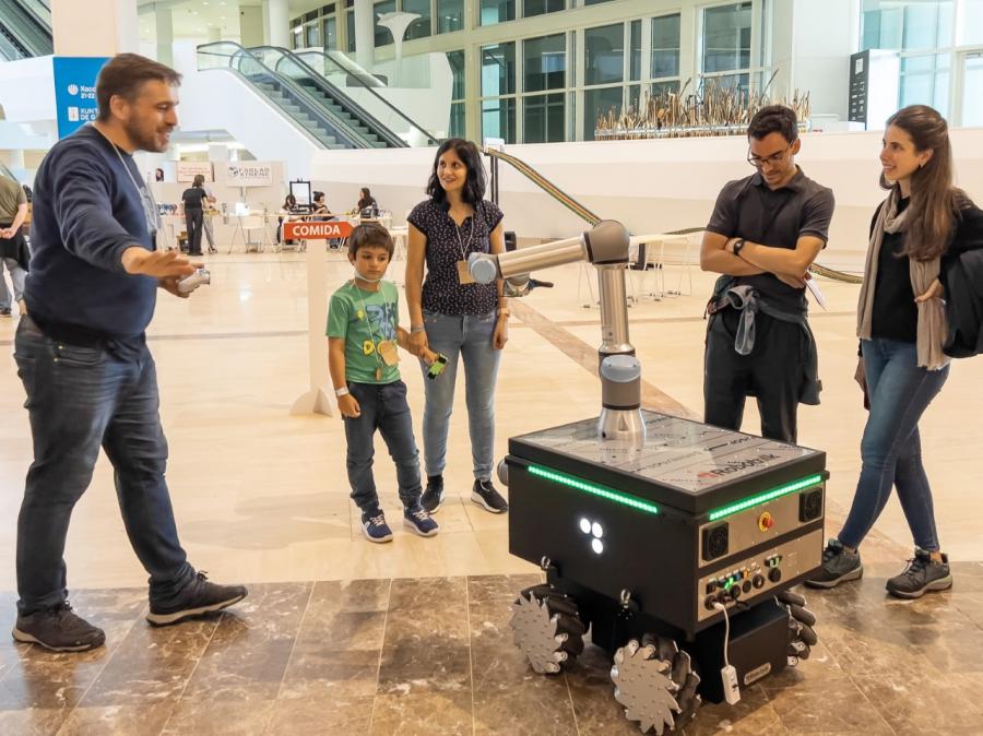Enrique Comesaña explica a visitantes as capacidades dun robot